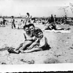 3 boys sitting on the beach