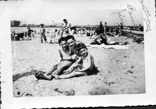 3 boys sitting on the beach