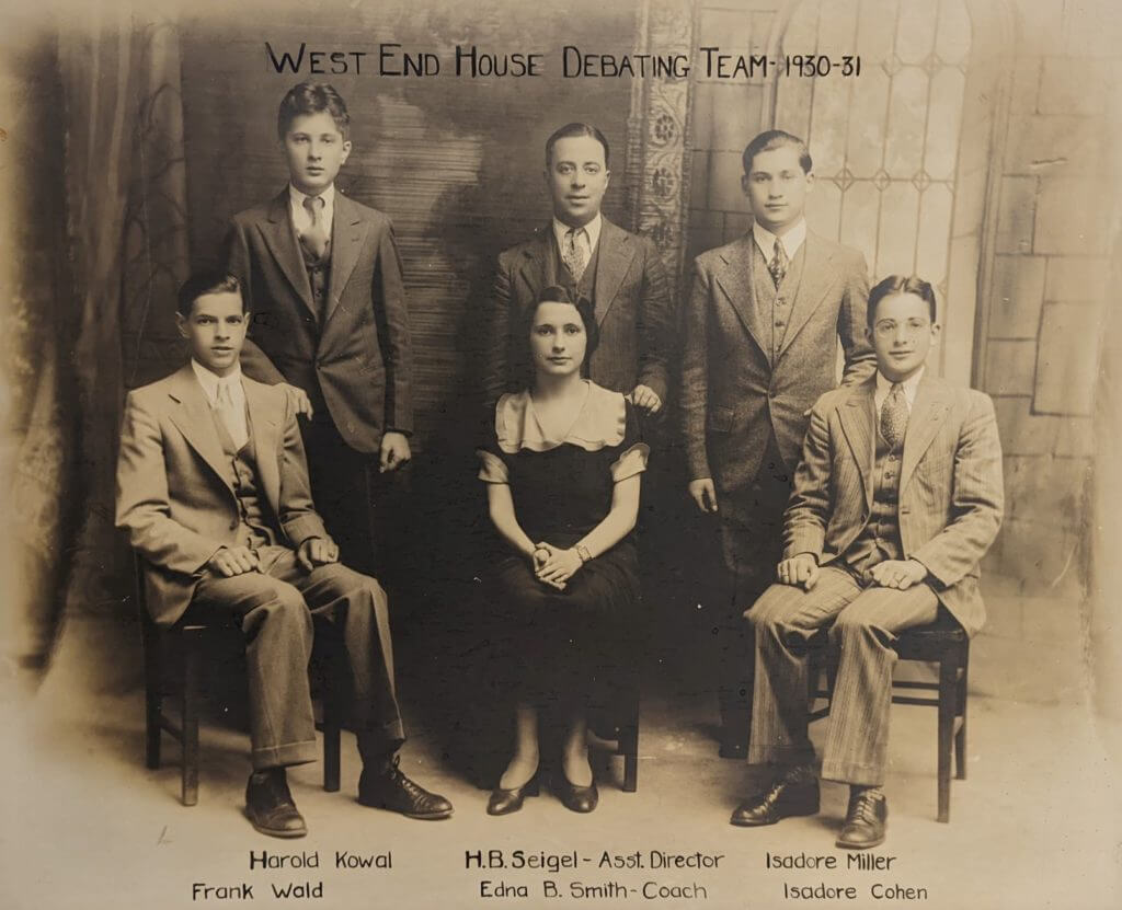Six persons sitting in 2 rows with a woman in the front center