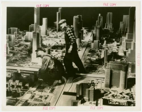Artists working on model buildings at Futurama, the models taller towers are about the same height as the men