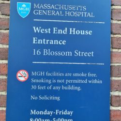 A blue sign reading West End House Entrance