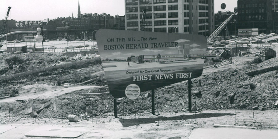 A demolished area with a sign marking the site of a new building for the Boston Herald Traveler