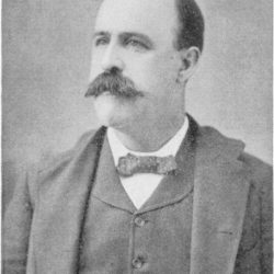 Portrait of a balding man with a large moustache