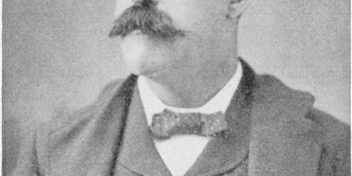 Portrait of a balding man with a large moustache
