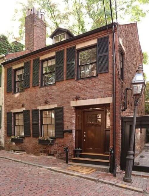 A 2-story brick home with a large chimney
