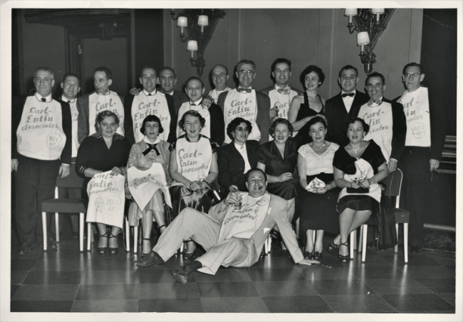 A group of men and women wearing bibs reading Carl Entin Association, WEH '45