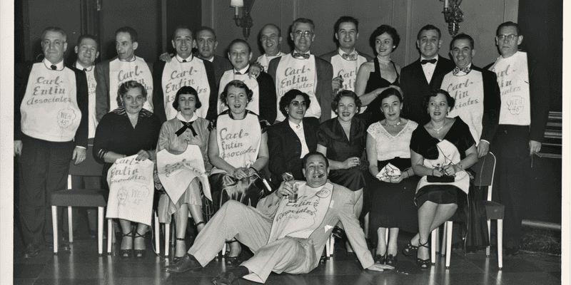 A group of men and women wearing bibs reading Carl Entin Association, WEH '45