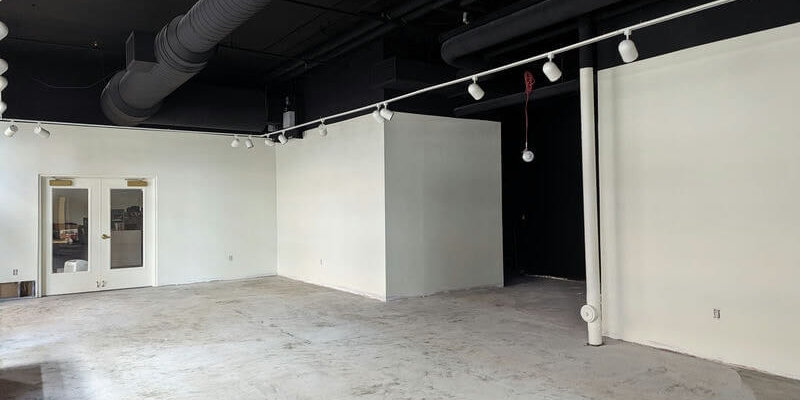 A room with fresh paint and a unfinished cement floor