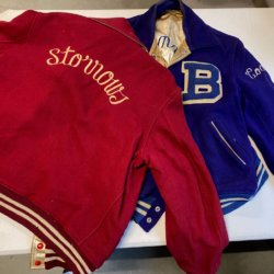 2 varsity jackets, one red, one blue, with the word Storrows (on red) and a large B (on Blue).