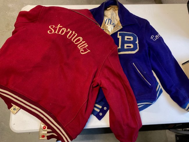 2 varsity jackets, one red, one blue, with the word Storrows (on red) and a large B (on Blue).