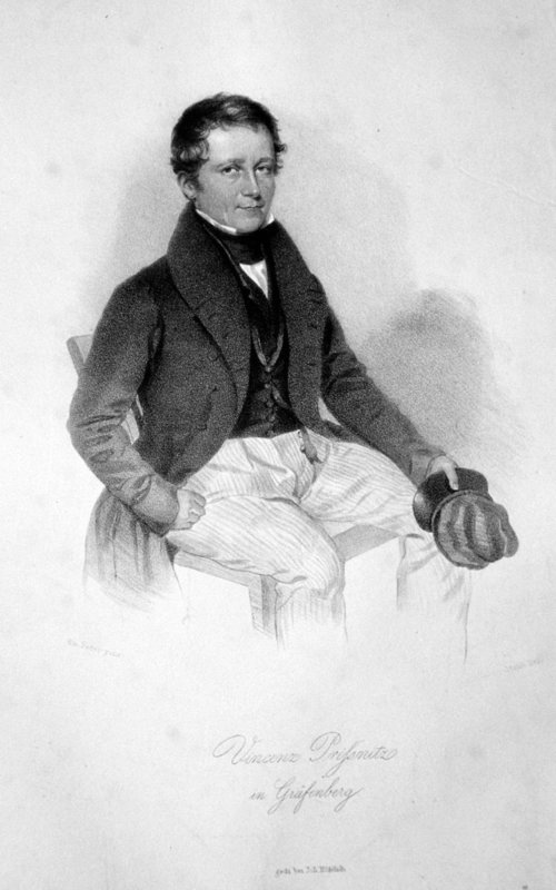 portrait of a man wearing a formal coat and a bow tie