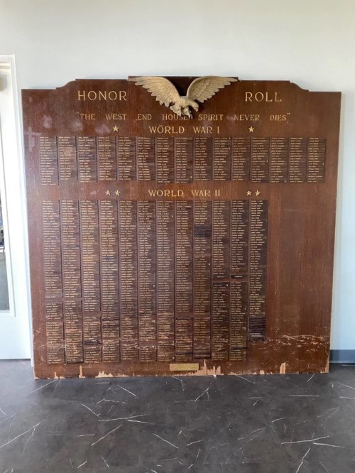 Photograph of a plaque titled Honor Roll with columns of names listed below.