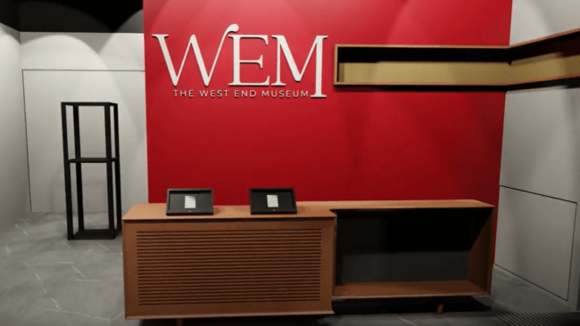 A rendering of the Museum's entry facing the greeter's desk, with a large logo sign. The entry door is out of frame to the right.