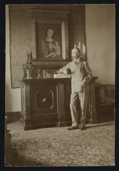 A 1904 photograph showing a middle-aged man standing in an Italian villa in front of a Madonna and Child painting.