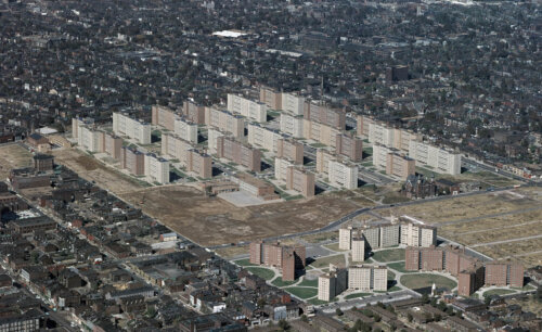 A photograph of a housing complex, with big isolated buildings.