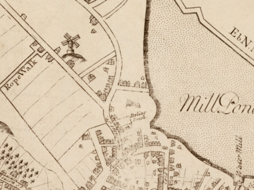 An eighteenth century map, showing an aerial view of Boston. The right is dominated by water (Mill Pond) and the left side some early streets, houses, and a windmill.