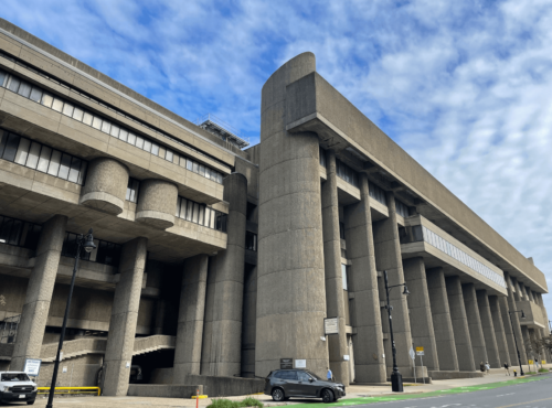 A photograph of a large, concrete brutalist building.