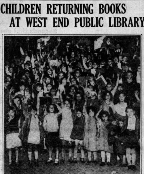 A large group of children pose with their arms in the air holding books under the headline "Children returning books at West End Public Library."