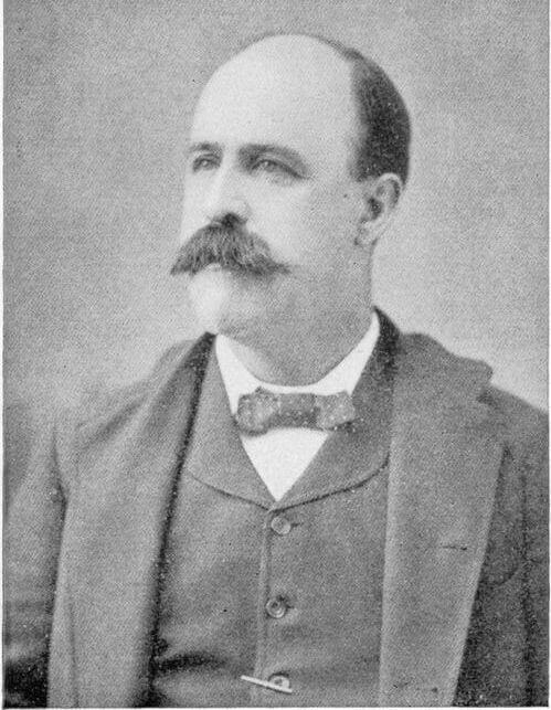 Portrait of a man in a suit with a large mustache.