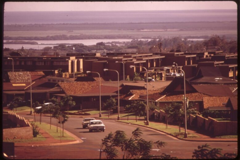 An areal photograph of a housing subdivision road.