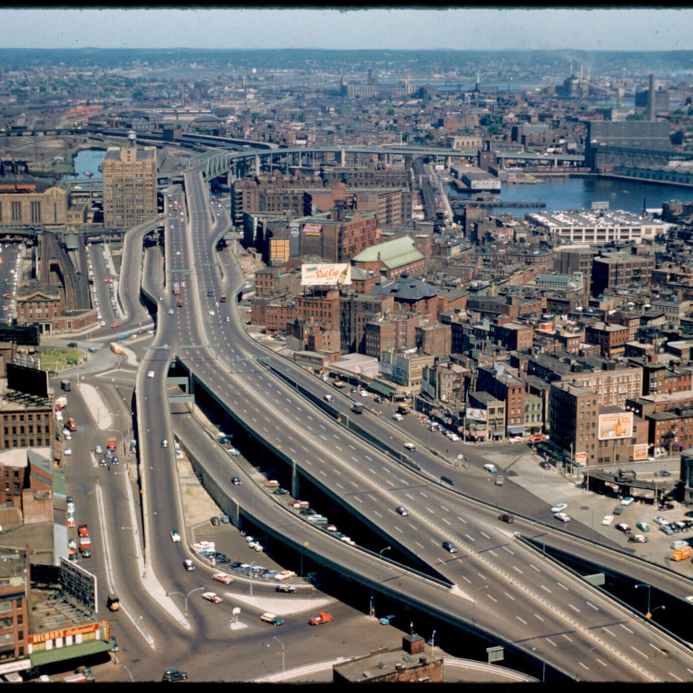 View of a highway from above that cuts through the center of a city.