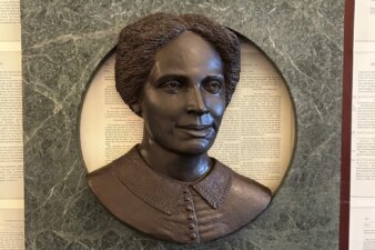 Hear Us detail, Sarah Parker Remond Bronze sculpture bust of a woman in a green marble fram.
