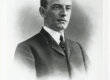 A black and white image of a man in a suit with slicked down hair.