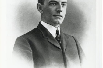 Daniel Whelton(1905)(City Archives) A black and white image of a man in a suit with slicked down hair.