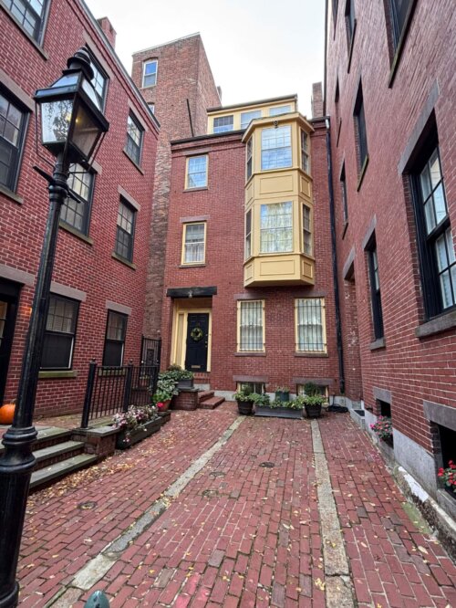 A brick building with yellow bay windows.