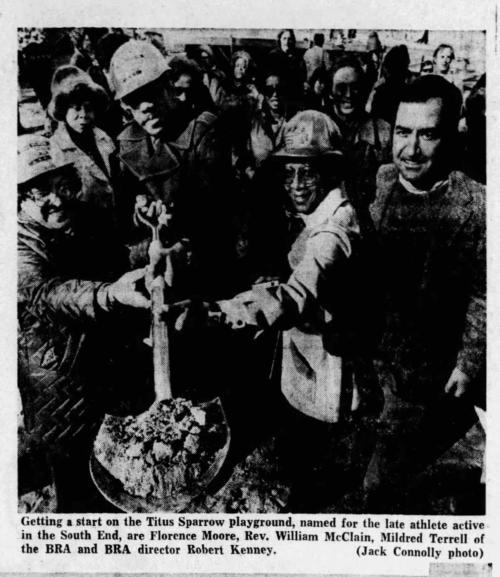 An image in a newspaper with a group of people holding a shovel for a ceremonial groundbreaking.