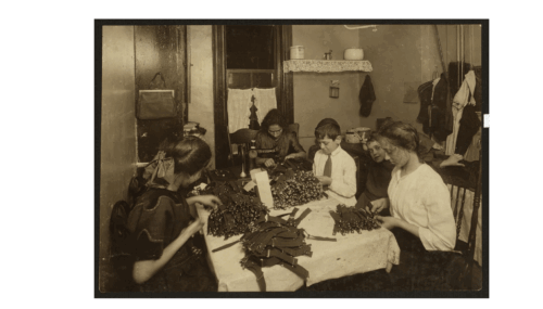 An image of a woman and four children working on garters in a small tenement.