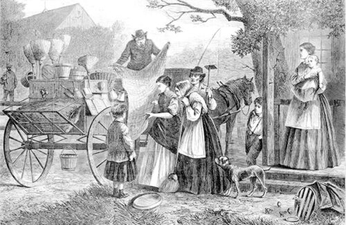 A man holding out a bolt of fabric while women and children inspect his wares.