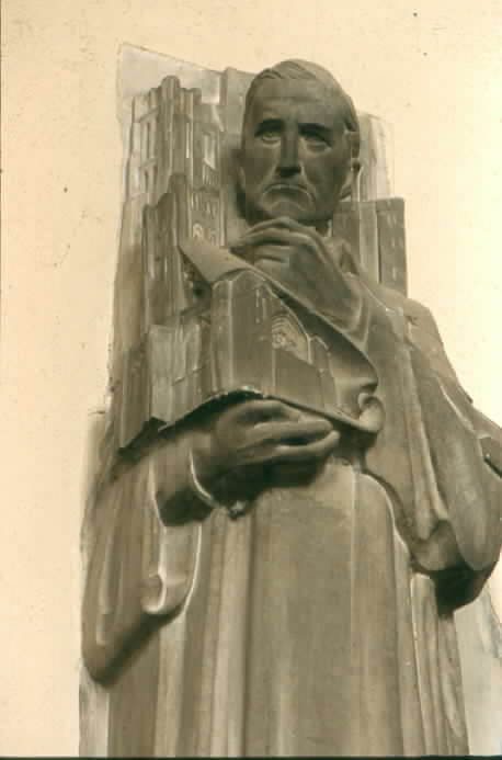 An art deco style sculpture of a man in robes holding up a model of a building.