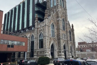 A gothic style church with a short glass tower rising from the nave.