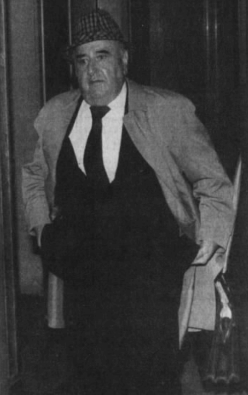 An image of an older man wearing a suit.