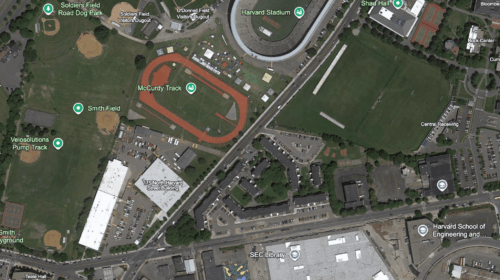 A satellite image of a neighborhood with two sports stadiums and several housing developments.