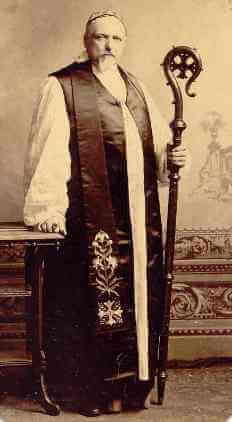 A priest in vestments holding a crosier.