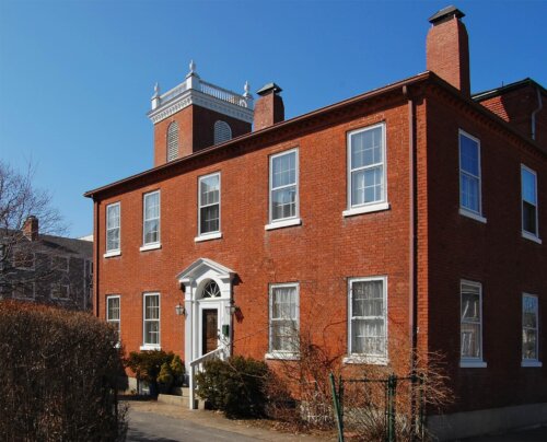 A two story brick federal style building.