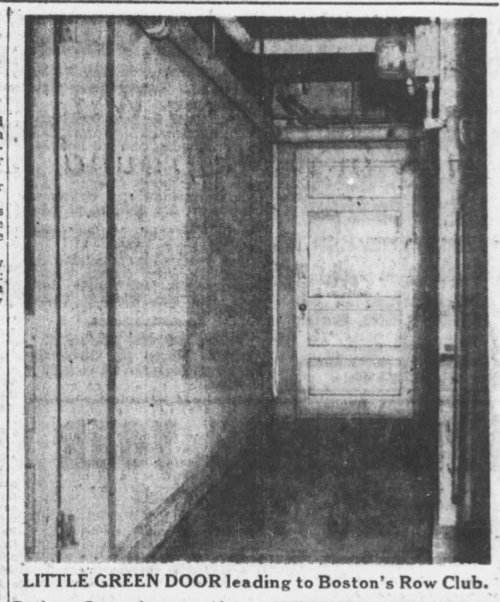 A dark hallway leading to a closed wooden door.