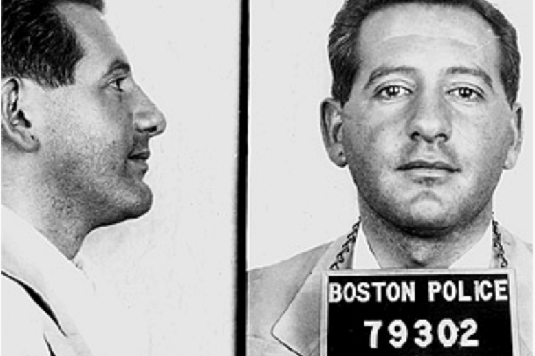 Elliot Paul Price Mugshot A profile and face on shot of a man with a five o'clock shadow. He has a Boston police prisoner placard around his neck.