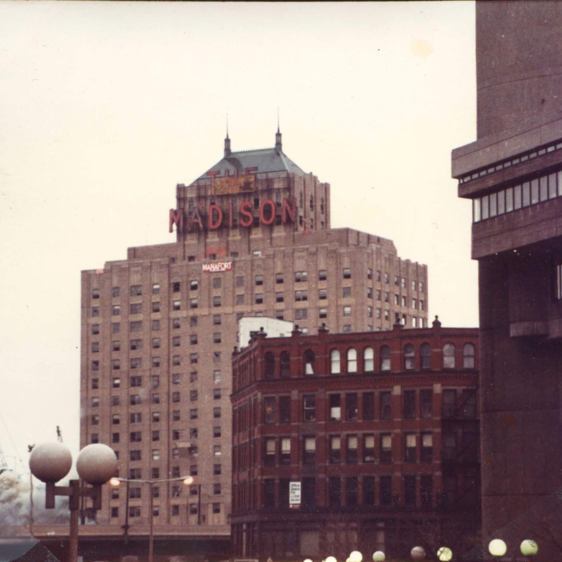 A tall hotel with the marquee that says Madison.