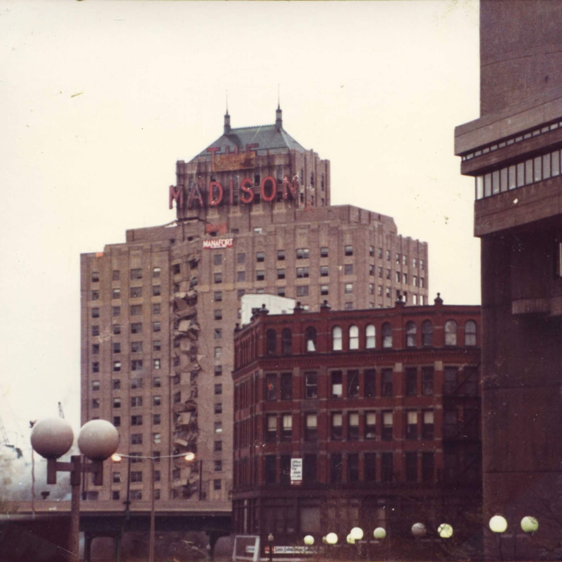 A tall hotel with the marquee that says Madison. The left side is starting to collapse.