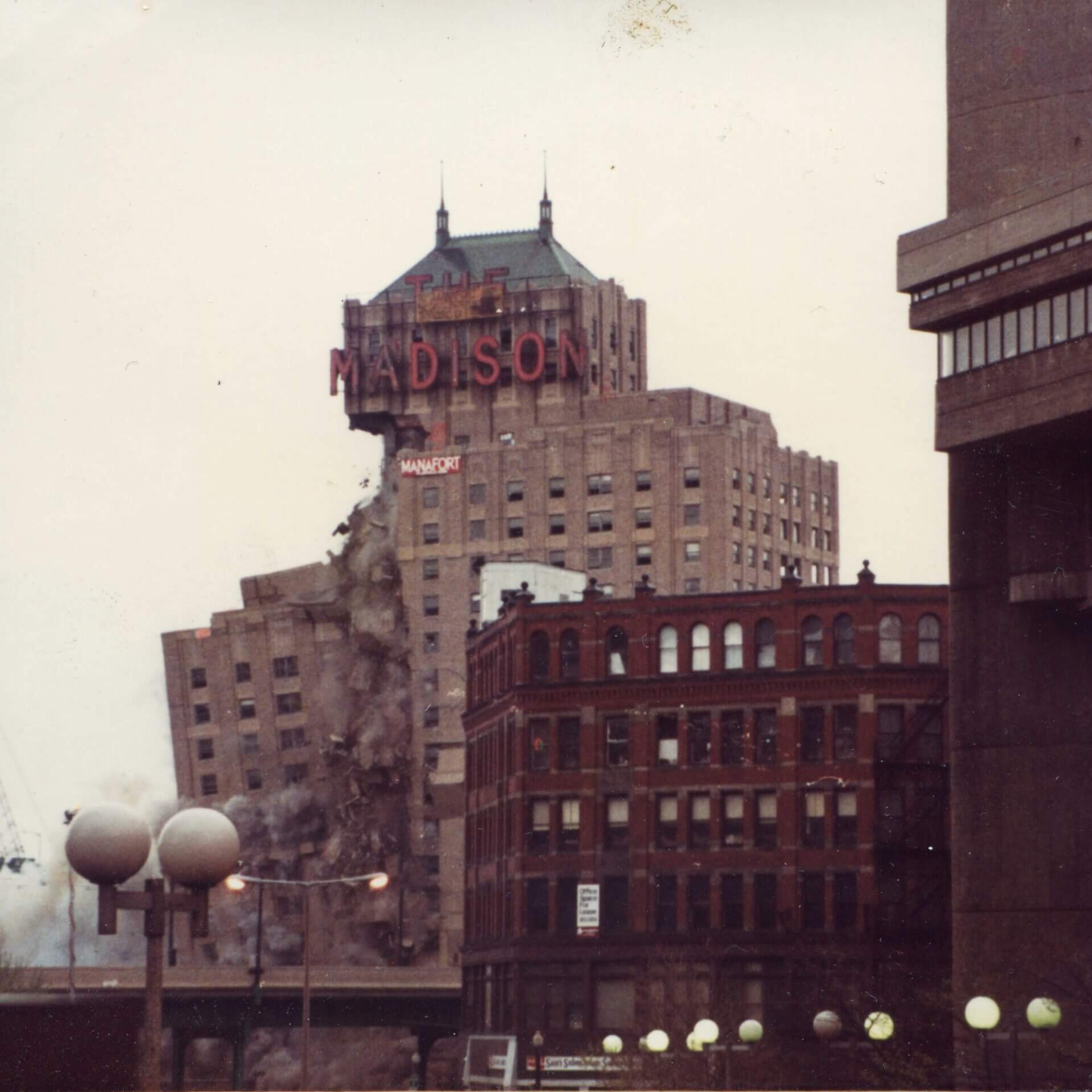 A tall hotel with the marquee that says Madison. The left side is almost totally gone.