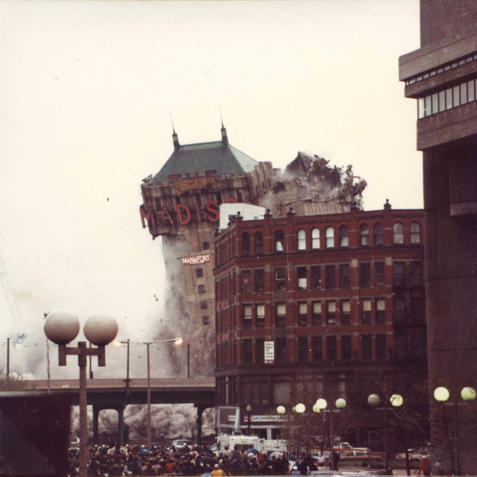A tall hotel with the marquee that says Madison. The right side is now mostly gone.
