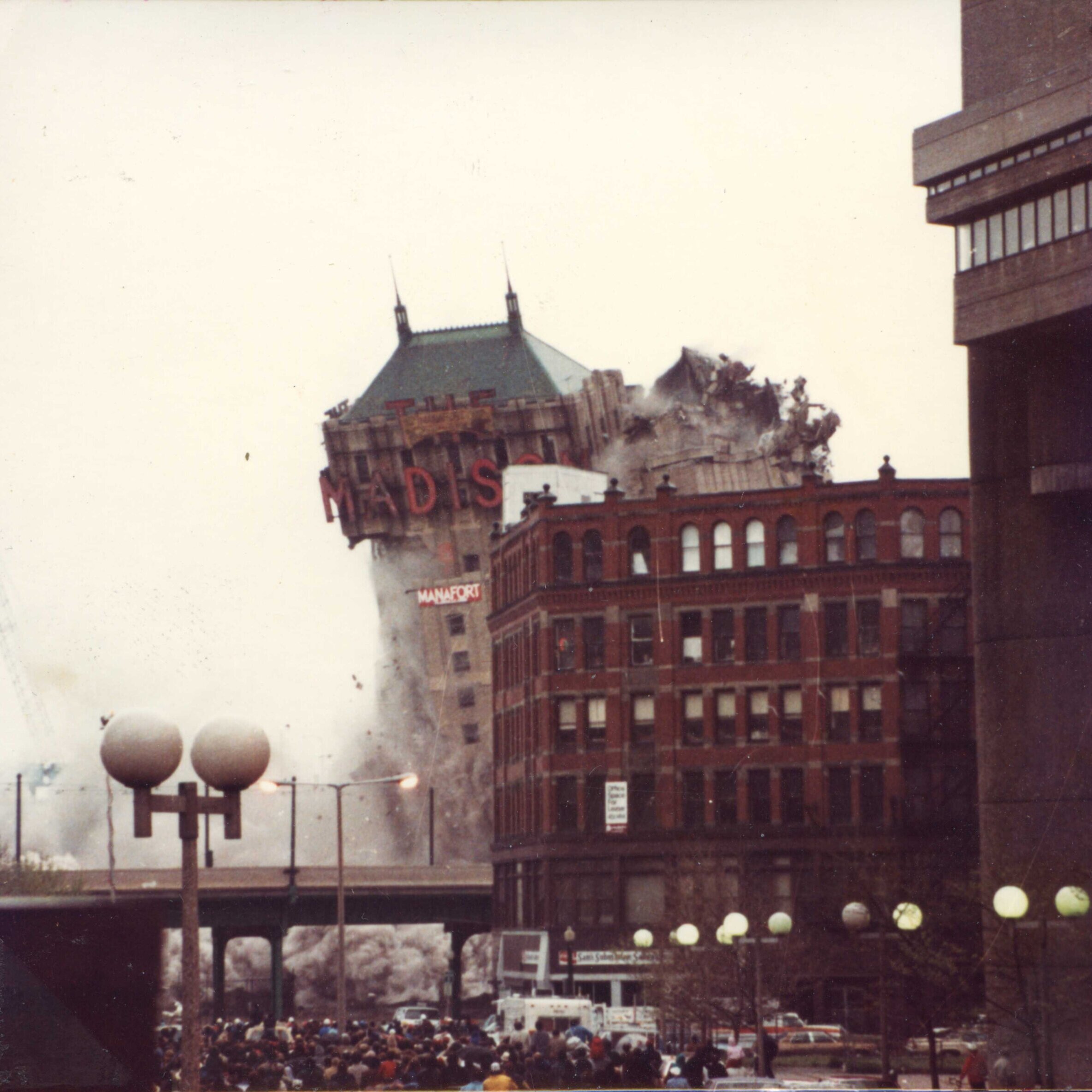 A tall hotel with the marquee that says Madison. The right side is now mostly gone.
