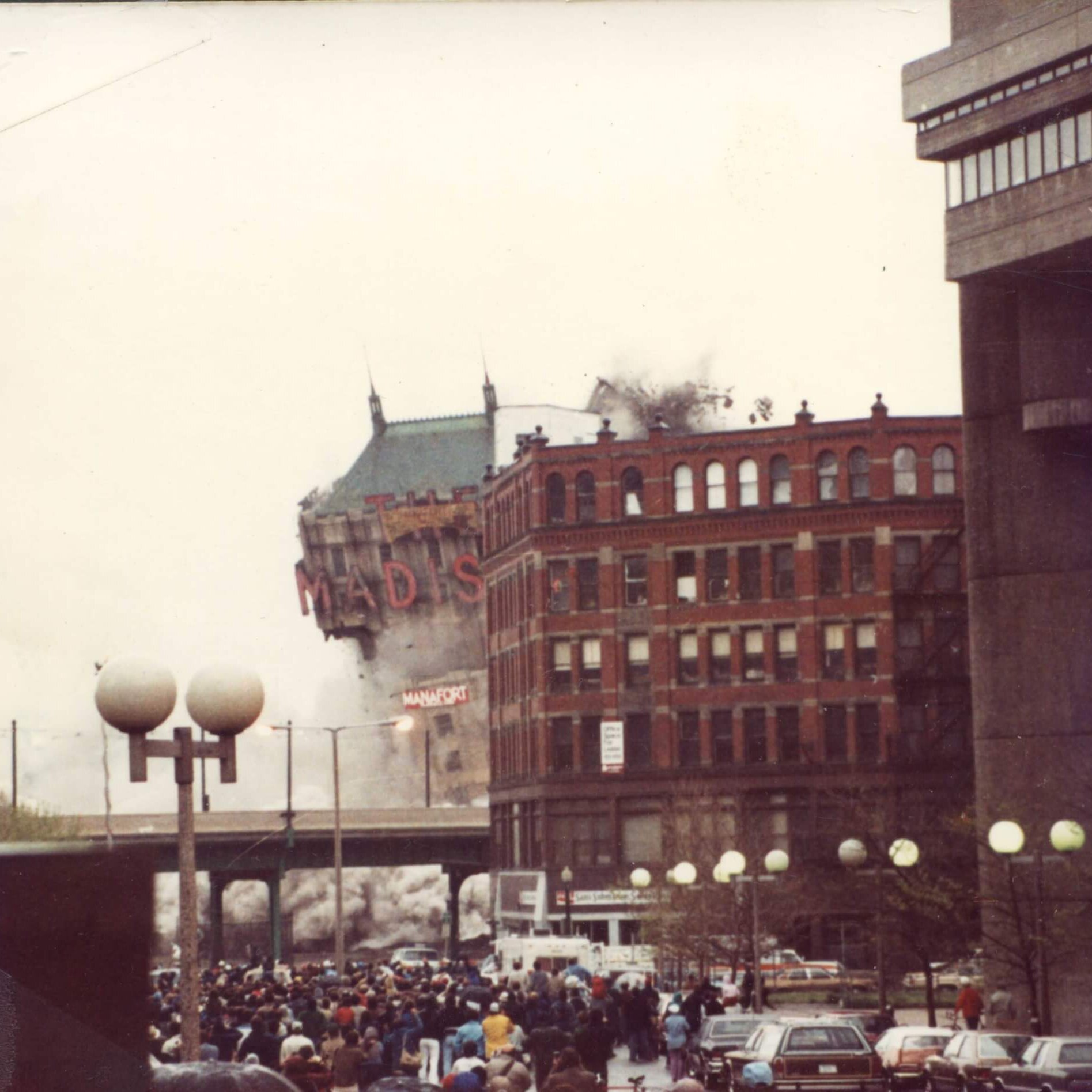 A tall hotel with the marquee that says Madison. All that's visible is the marquee and roof.