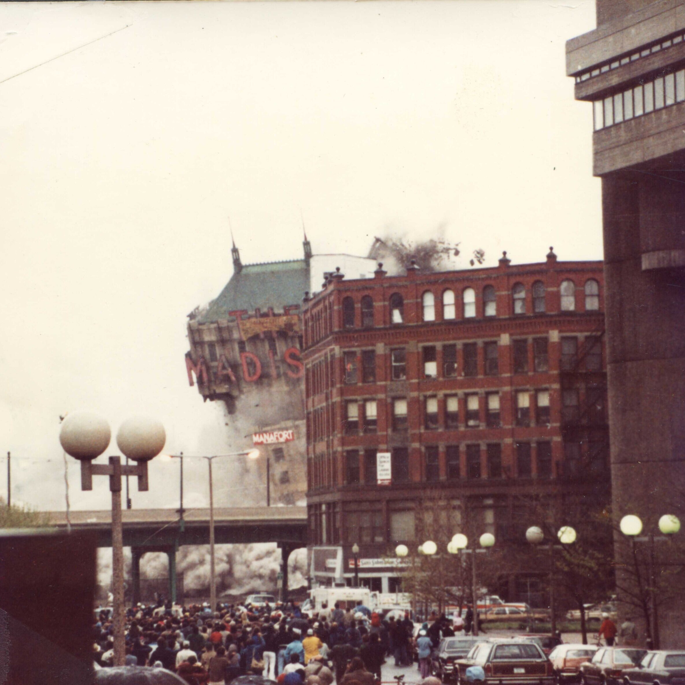 A tall hotel with the marquee that says Madison. All that's visible is the marquee and roof.