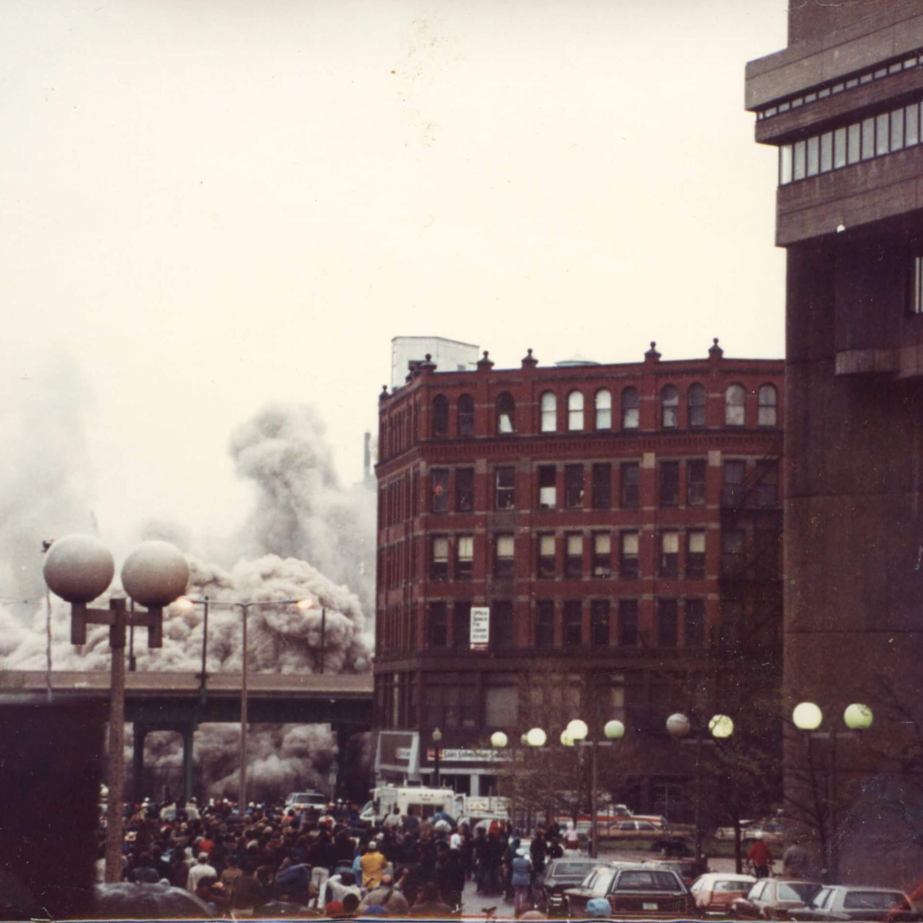 A tall hotel with the marquee that says Madison. All that can be seen is a dust cloud.