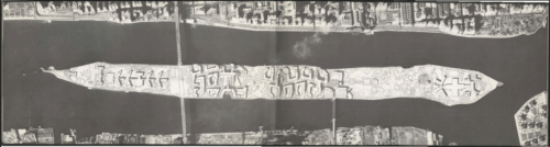A top down illustration of a long narrow island showing several buildings across the island. A bridge crosses through the island.