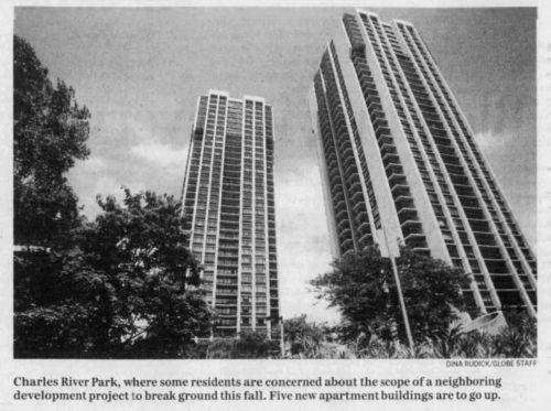 A newspaper clipping showing two residential towers from the ground.